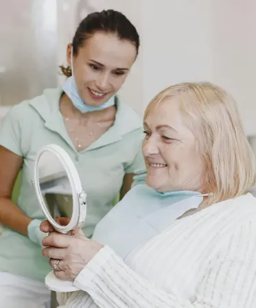 A old woman seeing her face on mirror